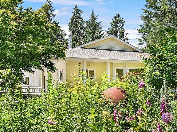 Home is nestled in the gardens with mature Japanese maples, roses and allium. Roof is new.