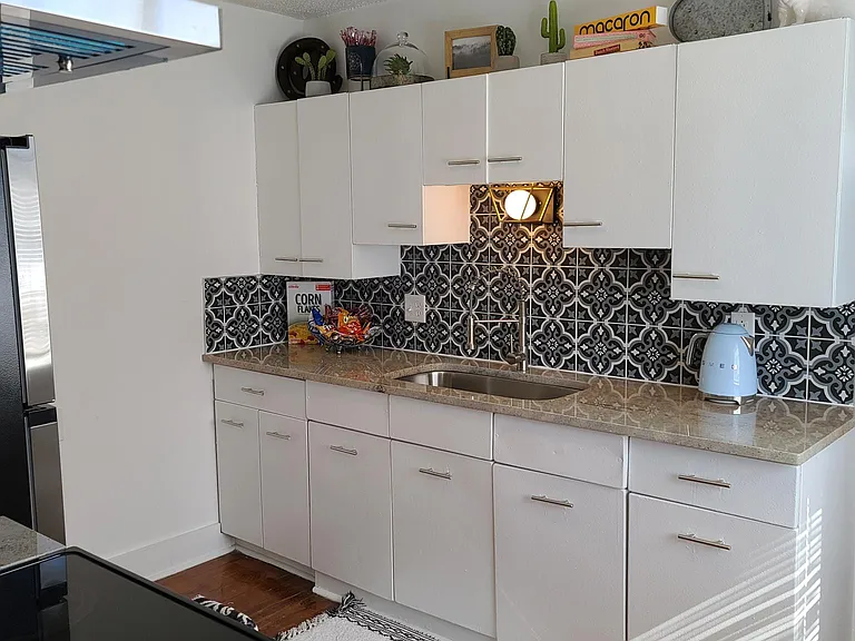 Kitchen with new Granite Countertops with Original Metal Cabinets, Stainless Steel Appliances, and Custom Tile Backsplash