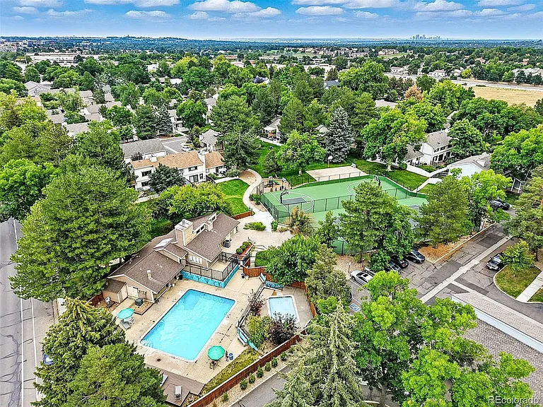 Ariel view of community clubhouse, pool, tennis court and basketball court.