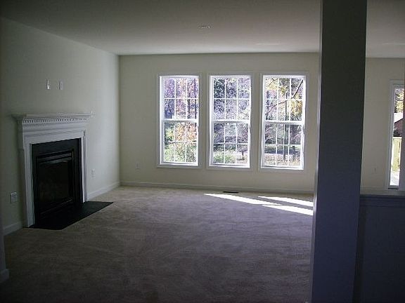 Family Room with Granite Surround Fireplace & Triple Window