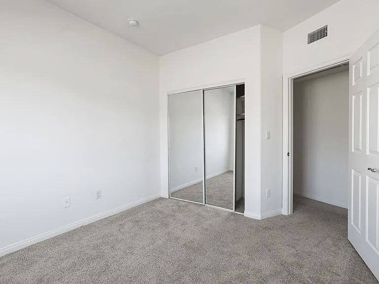 Bedroom with Mirrored Closet
