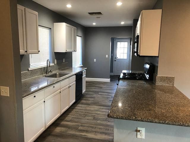 Kitchen with laundry room visible in the back