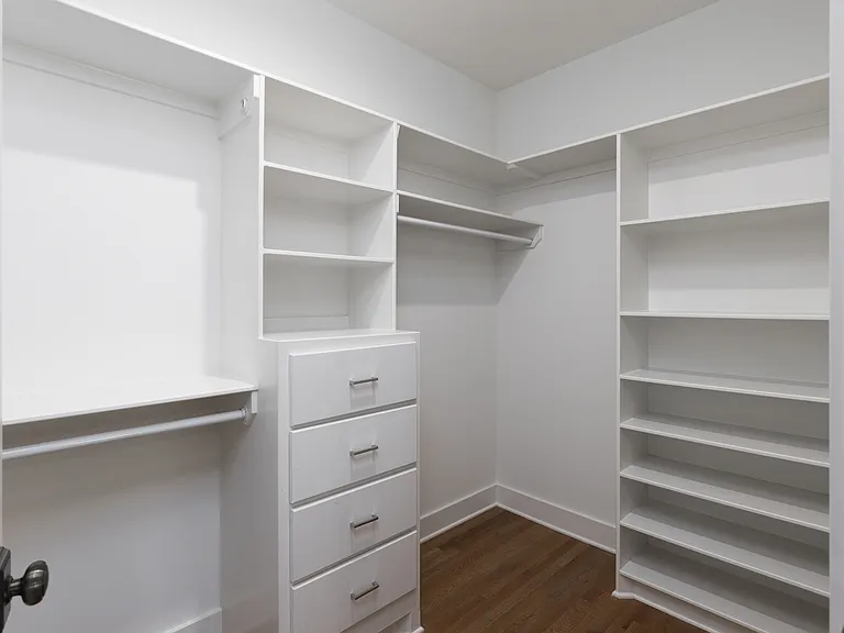 Primary bedroom on the 2nd floor with a king bed, Smart TV, ensuite bath, and room darkening shades. Includes a large walk-in closet. Tastefully decorated with high-end modern furnishings.