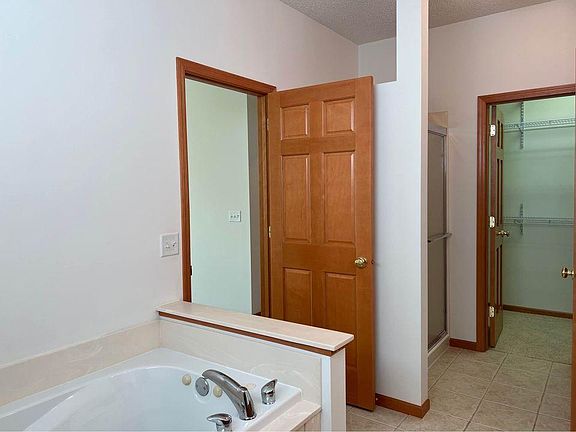 Master bathroom with soaker tub, separate shower, toilet and walk-in closet.