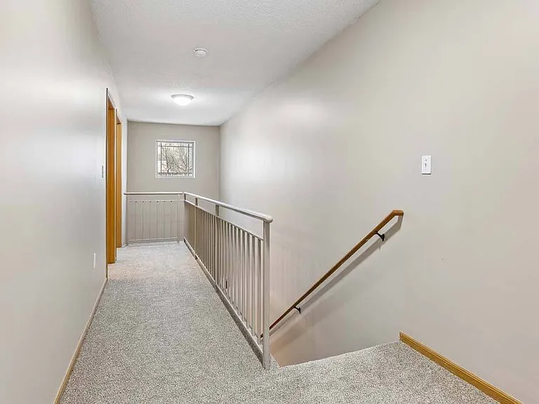 A clean, well-lit hallway that creates a smooth connection between levels and adds a sense of openness to the home.