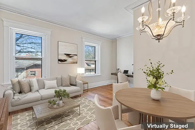 Photo of virtually staged living and dining room from front of room.