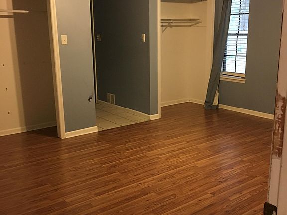 Master bedroom with his and her closets