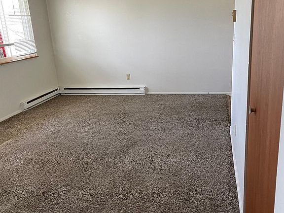 Living room view from hall. Coat closet, right