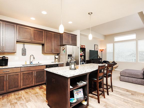 Open concept floor plan with large windows and high ceilings