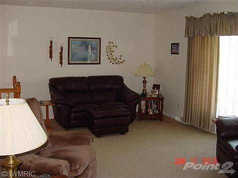 Large living room with window facing front yard and Johnson road.