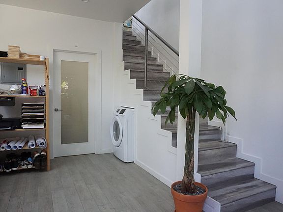 Stairs to 2nd floor, door to bedroom, washer hook-up (washing machine not included)