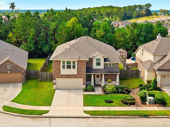 No back neighbors! Lovely green space views from your back yard! So close to Lake Conroe you can see it just over the trees - neighborhood boat launch for homeowners to use!!!