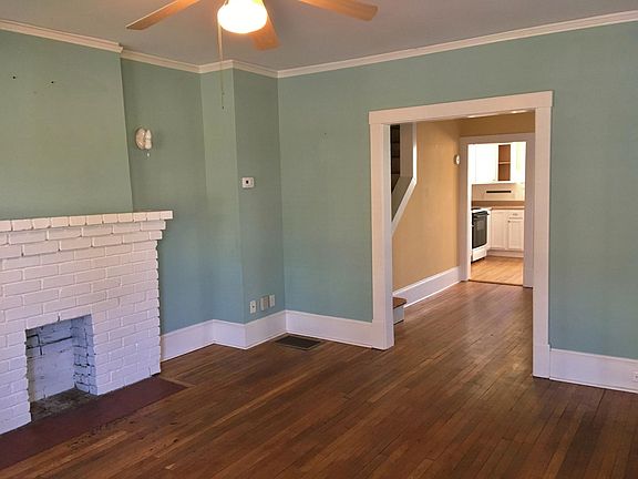 The living room has the original fireplace, wood floors and 9 foot ceilings with ceiling fan/light. It's cable and internet ready. The fireplace is for looks only, but adds charm. The yellow dining room beyond now has a new coat of white paint.