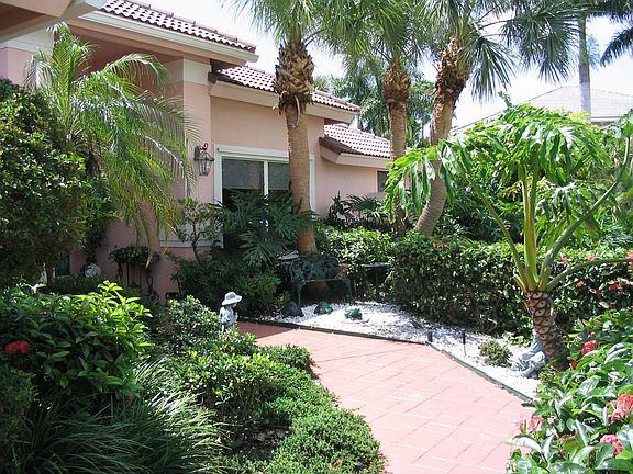Walkway to the front entrance with private sitting areas.
