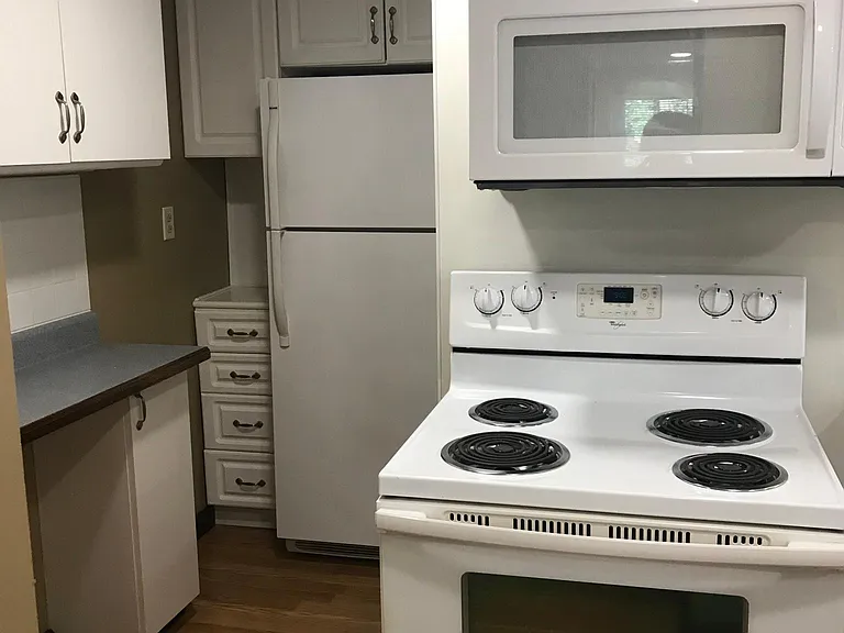 Additional counter space for coffee bar, appliances and storage. Under cabinet lighting. Refrigerator with storage overhead and to the left.