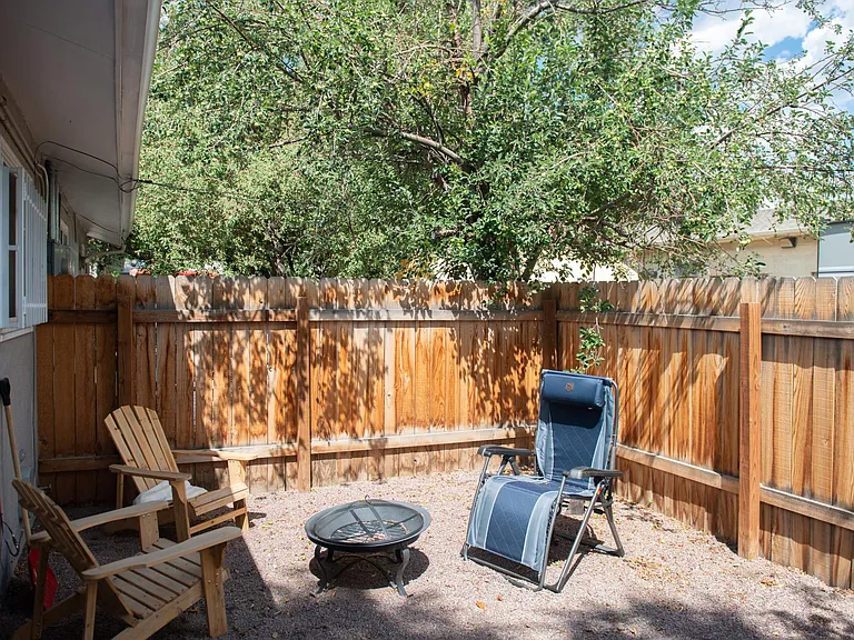 Private fenced back yard with apple tree.