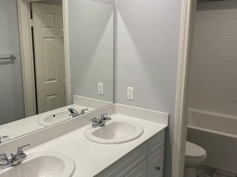 upstairs guest bathroom with dual sinks