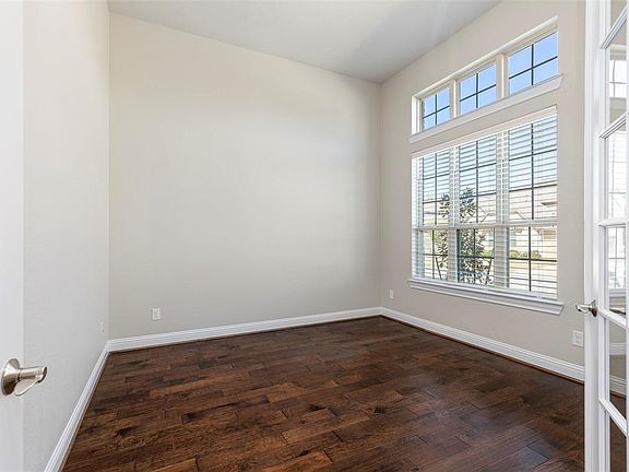 The Office is located behind French doors and overlooks the front yard