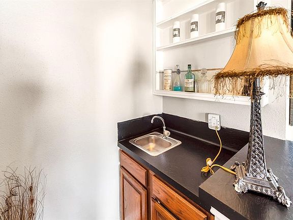 A wet bar is convenient to the living room.