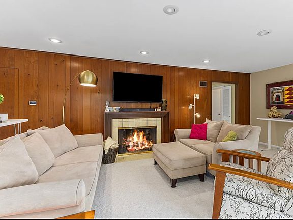Back living room that looks out to mature trees and recently updated landscaping