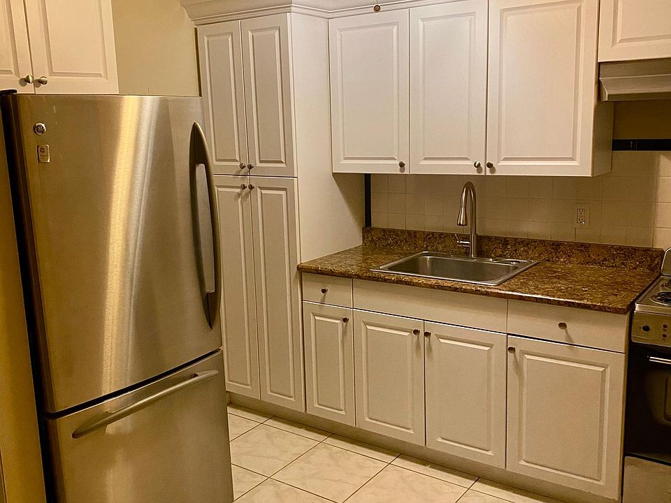 Kitchen with stainless steel fridge and plenty of storage
