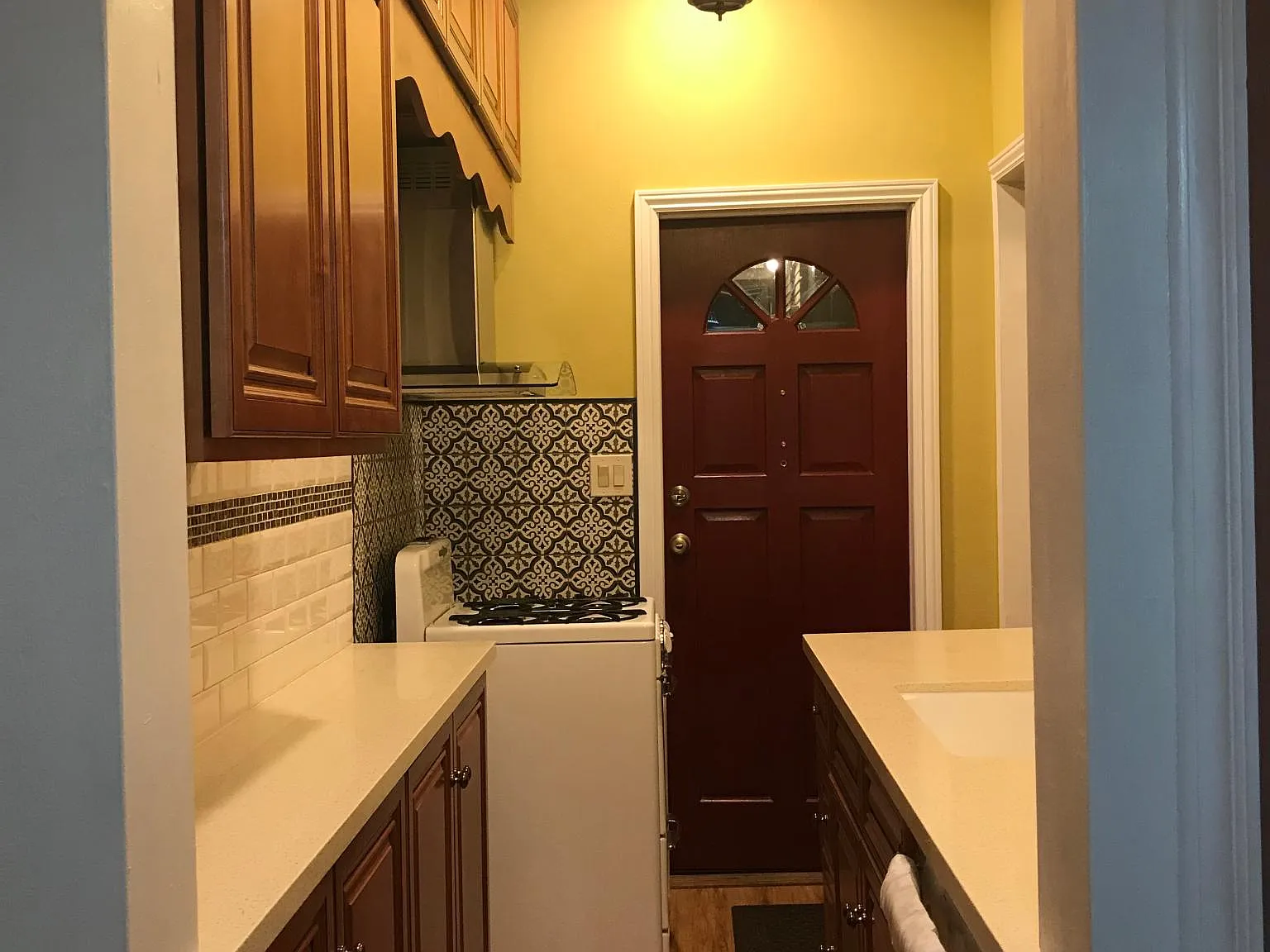 overall view of kitchen from doorway of breakfast room looking toward front entry door