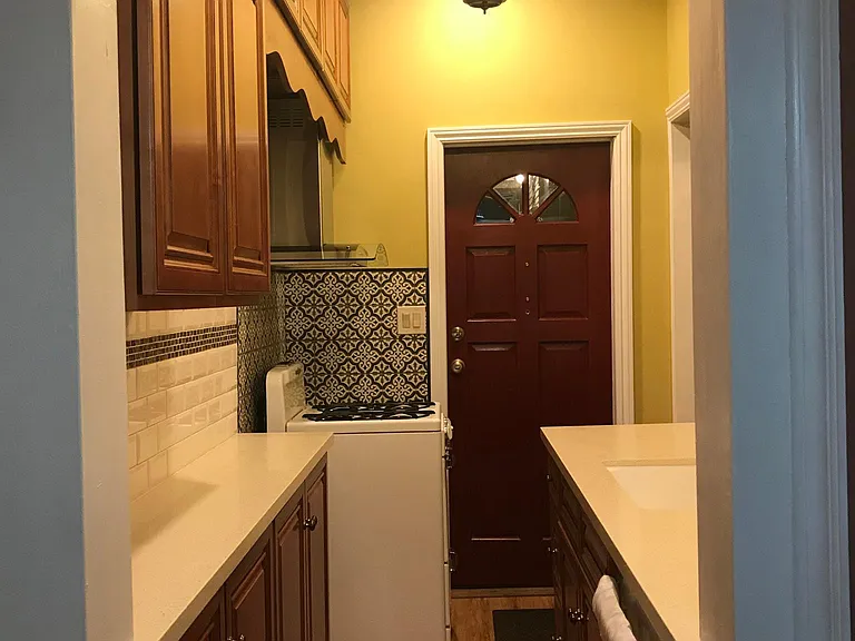 overall view of kitchen from doorway of breakfast room looking toward front entry door