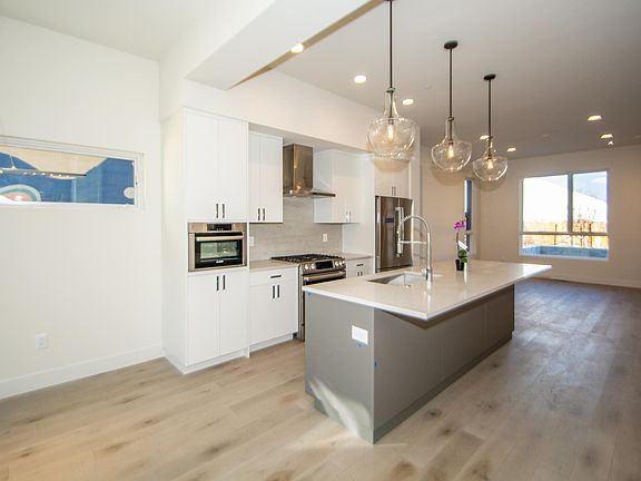 Spacious kitchen between dining room and living room.