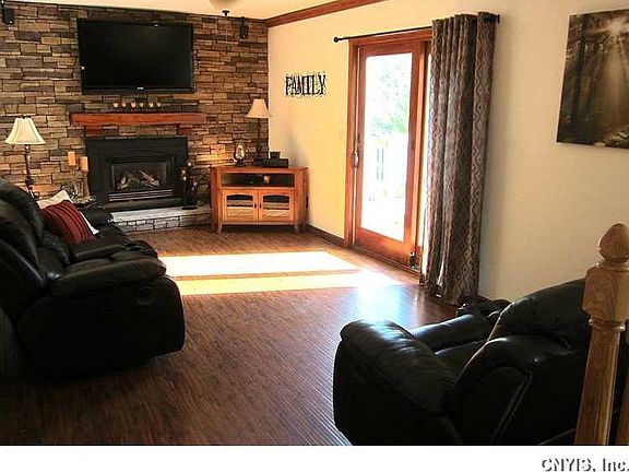 Family Room. The spacious Family Room is a step-down from the Kitchen and features a new Anderson sliding glass door, new easy care laminate flooring, new ceiling fan, and a raised hearth gas fireplace with a brand new stone "face lift"!
