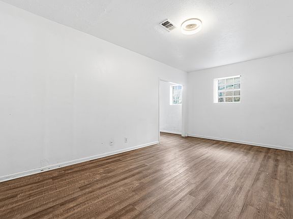 The lower level features a separate studio-style suite with its own full bathroom, kitchen, and private entrance ideal for a guest suite, home office, or bonus living space.