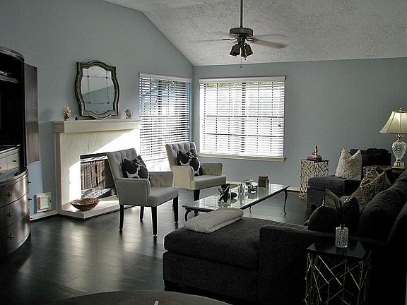 The living room features a gas log fireplace.