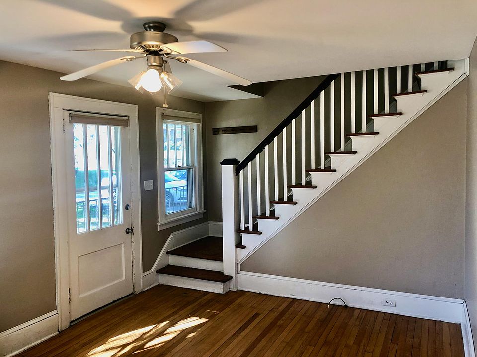 Living room and stairs looking towards front door.