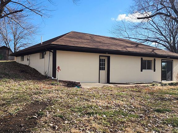 Storage sheds for mower behind home.