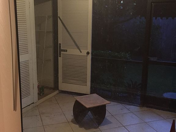 screened in outdoor sitting area with laudry