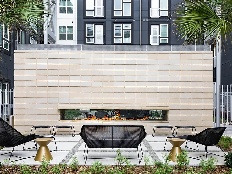 Enjoy the warmth and ambiance of a double-sided fireplace in the courtyard, perfect for relaxing evenings under the stars.