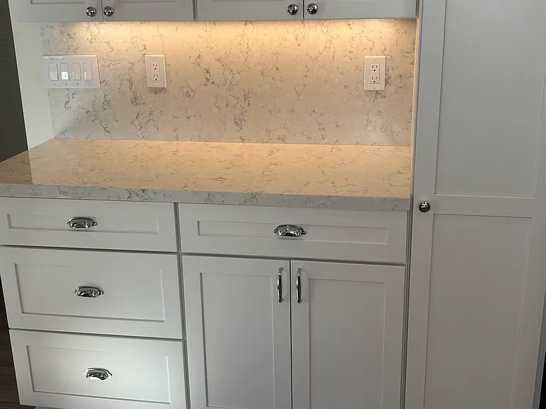 Quartz countertops, polished chrome fixtures and under counter lighting.