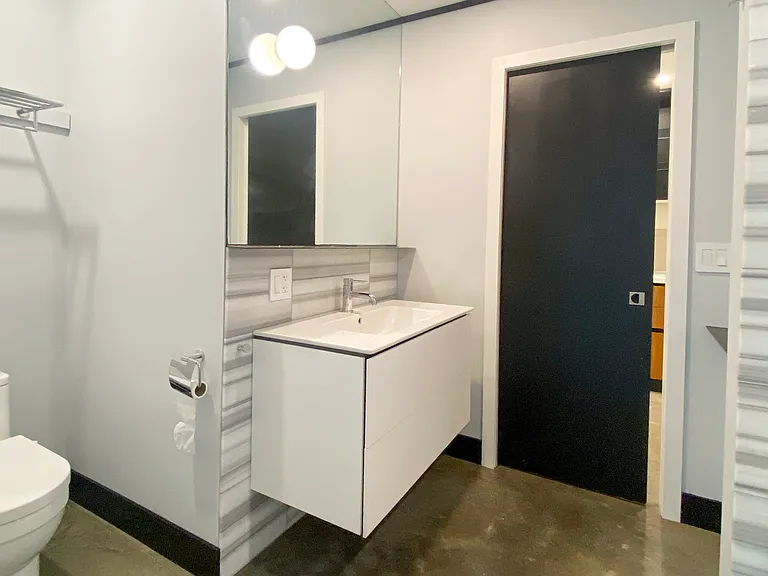 Bathroom with marble tiles and built-in vanity storage