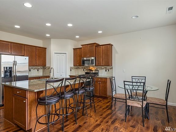 Kitchen. Huge slab counter- lots of room for prep and eating! All Stainless Steel Appliances were new with home in 2014 and stay with new buyer!