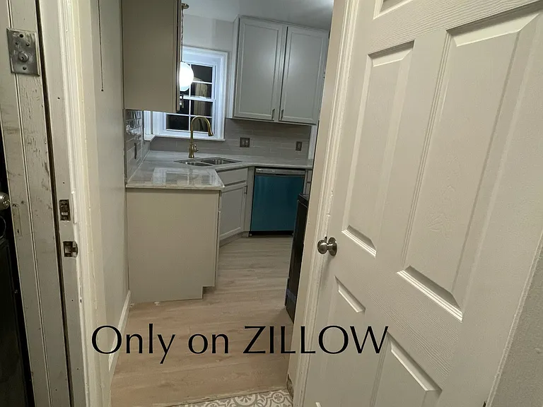 Passage between kitchen, bathroom, basement door and back door.