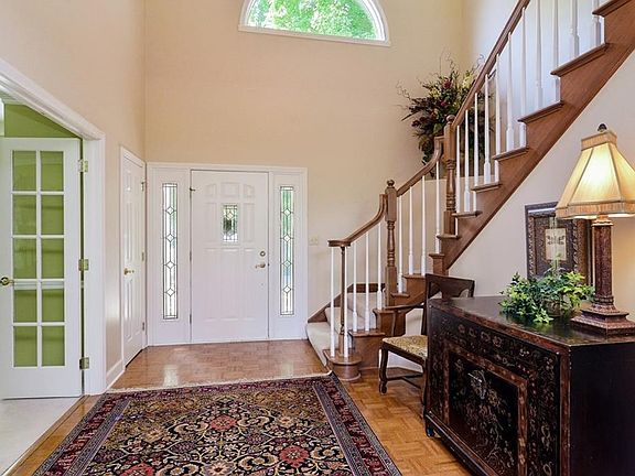 Soaring entry way with a beautiful staircase!