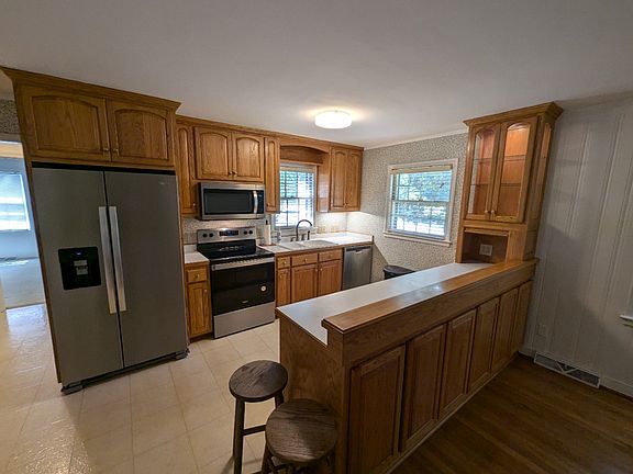 The kitchen is furnished with appliances and abundant storage.