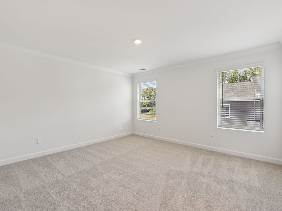 Relax and unwind after a long day in the primary bedroom.