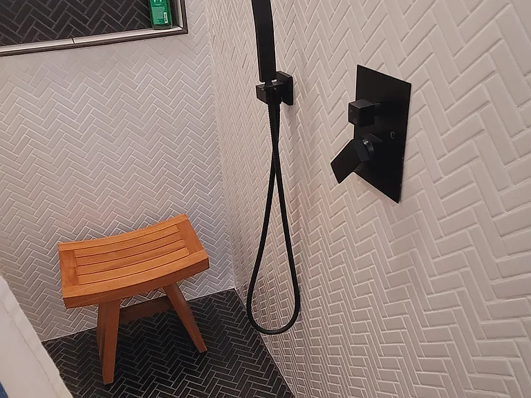 New chevron tiled shower with overhead waterfall