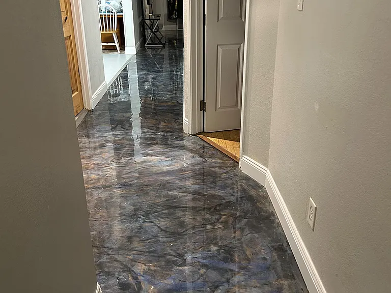 Hallway with durable high-gloss flooring and easy access to adjacent rooms, offering a convenient path through the home.