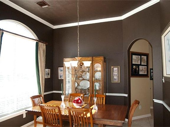 Formal Dining with designer paint, chair rail, and high ceilings.