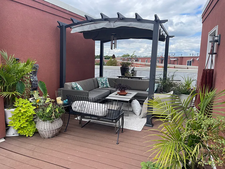 Private rooftop deck with covered seating area