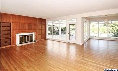 #5 Living room with built-in bookcases, wood paneled walls and floor-ceiling windows