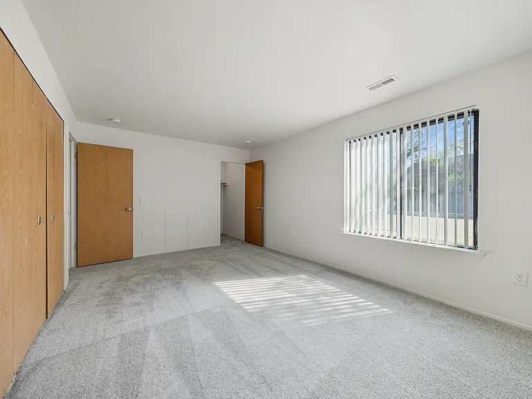 Large bedroom with natural light at Franklin River Apartments in Southfield, MIng Room with natural light at Franklin River Apartments in Southfield, MI