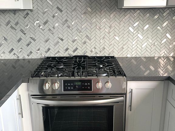 Stainless steel slide-in oven with stainless steel hood