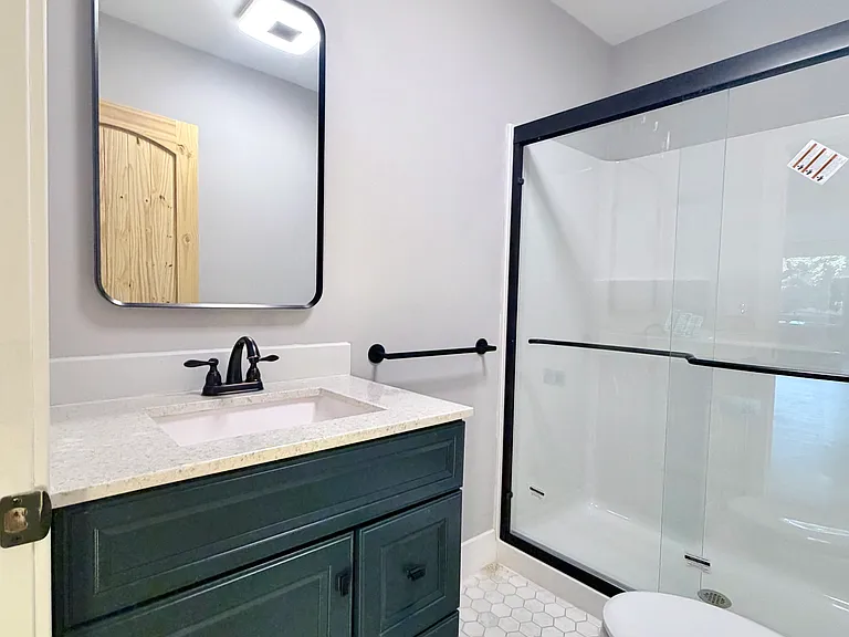 Modern full bath between bedrooms | Walk-in shower with glass enclosure | New 2026 renovation